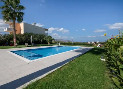 a swimming pool in front of a villa at Socrates Holidays Apt 4 with Pool near the Beach in Kamisianá