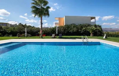 a swimming pool in front of a villa at Socrates Holidays Apt 4 with Pool near the Beach in Kamisianá
