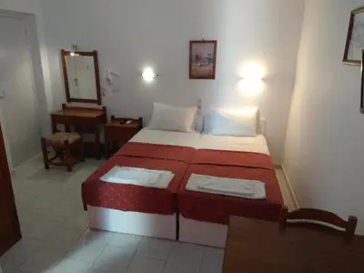 a hotel room with a bed and a mirror at Villa Giorgos in Plataniás