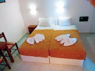 a bedroom with a bed with two towels on it at Villa Giorgos in Plataniás