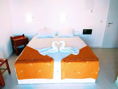 a bedroom with a large bed with two bows on it at Villa Giorgos in Plataniás