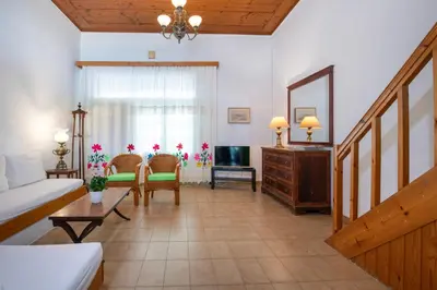 a living room with a couch and a table at Ismini Apartments in Kalyves