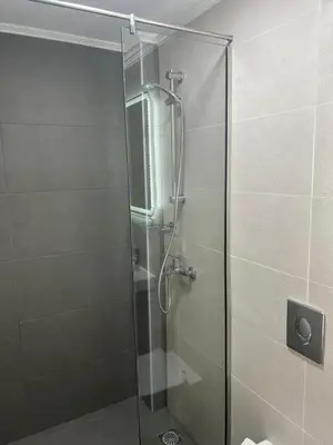 a shower with a glass door in a bathroom at Hotel Lefka Ori - City Rooms in Chania Town