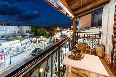 a balcony with a table and a view of a street at Evelinas House Platanias in Plataniás