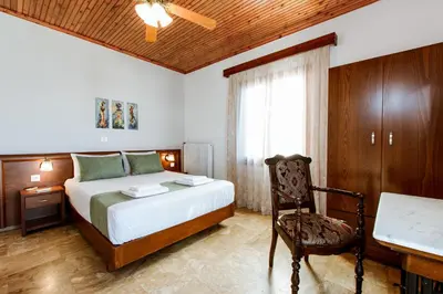 a bedroom with a bed and a chair and a desk at Evelinas House Platanias in Plataniás