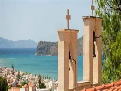 a church with crosses on top of a building at Modern holiday home in Stalos with balcony in Stalos
