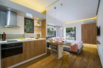 a kitchen with a sink and a table in a room at Nest of Marmel Luxury Studio in Chania Town