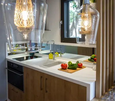 a kitchen with a sink and some vegetables on a cutting board at Nest of Marmel Luxury Studio in Chania Town