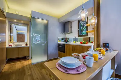 a kitchen with a table with plates of food on it at Nest of Marmel Luxury Studio in Chania Town