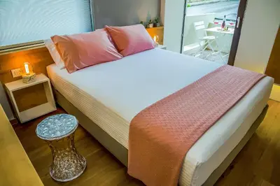 a bedroom with a bed and a small table at Nest of Marmel Luxury Studio in Chania Town
