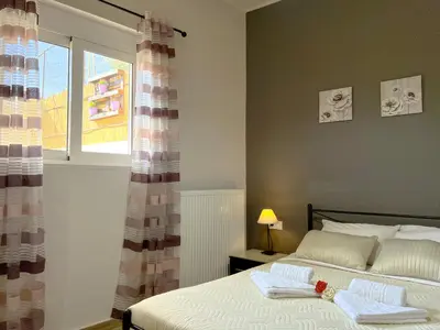 a bedroom with a bed with two towels on it at Antigoni's Studio Cozy Private Apartment in Kissamos