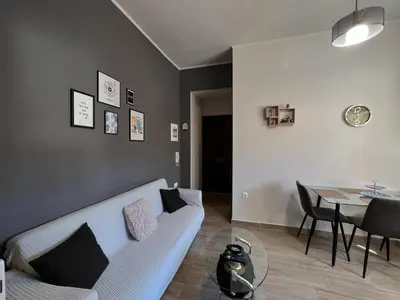 a living room with a white couch and a table at Antigoni's Studio Cozy Private Apartment in Kissamos