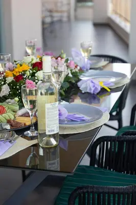 a table with a bottle of wine and glasses on it at Superior Villa Kleanthi in Stalos