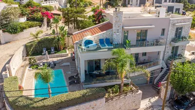 an aerial view of a house with a swimming pool at Superior Villa Kleanthi in Stalos
