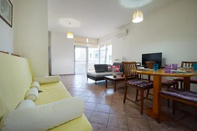 a living room with a couch and a table at Sunny Apartment in Daratso