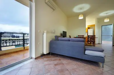a living room with a couch and a balcony at Sunny Apartment in Daratso