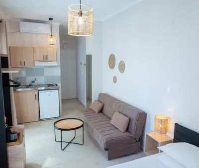 a living room with a couch and a kitchen at Mare I - studio in Old Harbor in Chania Town