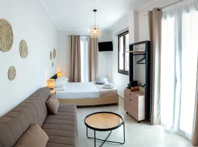 a living room with a couch and a bed at Mare I - studio in Old Harbor in Chania Town