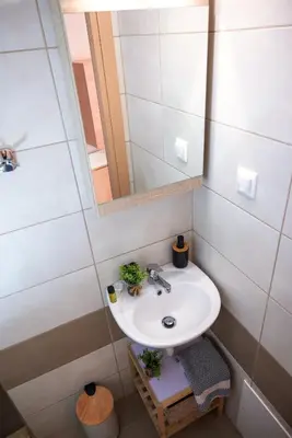a bathroom with a sink and a mirror at Mare II - Studio in Old Harbor in Chania Town