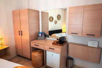 a bedroom with a dressing table and a mirror at Mare II - Studio in Old Harbor in Chania Town