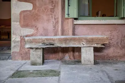 a stone bench sitting in front of a building at Lemon Tree Eco-Retreat in Gavalochori