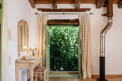 an open door in a room with a desk and a window at Lemon Tree Eco-Retreat in Gavalochori