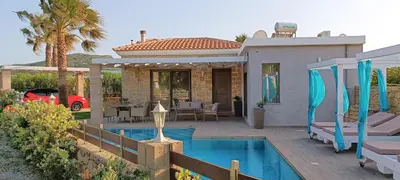 a house with a swimming pool in front of a house at Elena Villa in Kissamos
