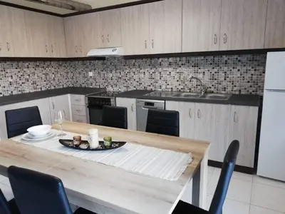 a kitchen with a table with a plate of food on it at Anatoli View in Agia Marina Nea Kydonias