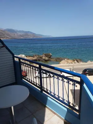 a balcony with a view of the ocean at Galini Studios in Palaiochóra