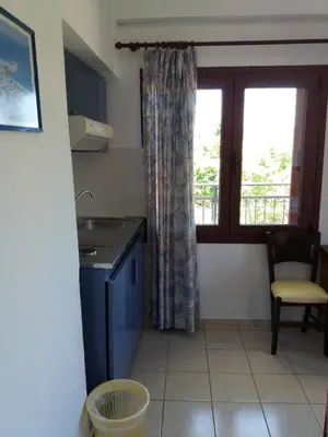 a small kitchen with a sink and a window at Oasis Studios in Palaiochóra
