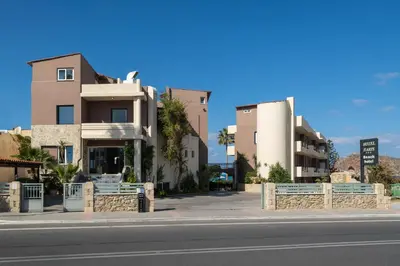 a building on the side of a street at Hotel Haris on the beach in Agia Marina Nea Kydonias