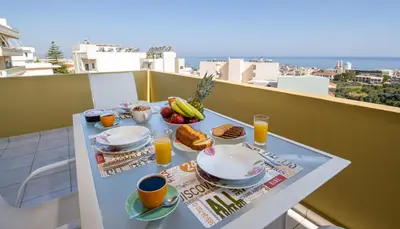 a table with breakfast food and drinks on a balcony at Casa di Halepa in Chania Town