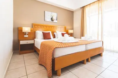 a bedroom with a large bed in a room at Helios Apartments in Kato Daratso