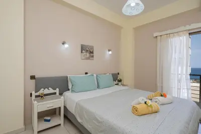 a bedroom with a bed with two stuffed animals on it at Elita beachfront in Chania Town