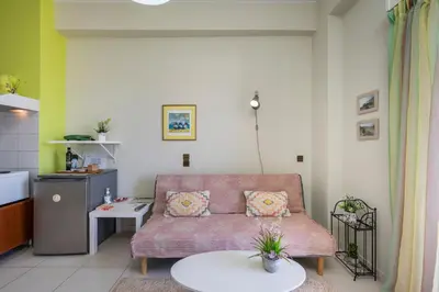 a living room with a couch and a table at Elita beachfront in Chania Town
