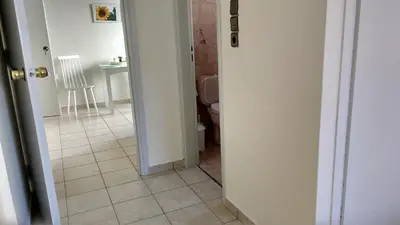 a bathroom with a toilet and a tiled floor at Elita Beachside in Chania Town