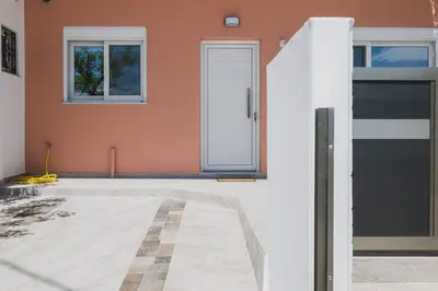 a house with a black and white front door at Spacious Home with Parking in Chania Town