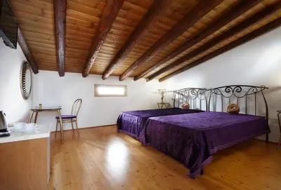 a bedroom with a bed and a wooden ceiling at Casa Perla Suites in Chania Town