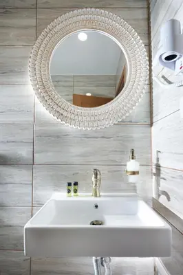 a bathroom with a white sink and a mirror at Casa Perla Suites in Chania Town