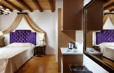 a hotel room with two beds and purple headboards at Casa Perla Suites in Chania Town