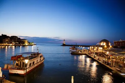 a couple of boats docked in the water at night at La Barchetta Old Town Home with Seaview in Chania Town