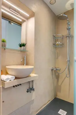 a bathroom with a sink and a shower at La Barchetta Old Town Home with Seaview in Chania Town