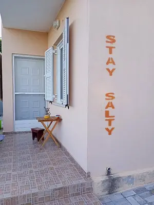 a sign on the side of a building next to a door at Stay Salty - Two Different Houses in Marathi