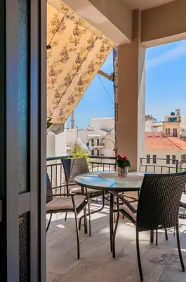a patio with a table and chairs on a balcony at Sophia's Castle View Apartment in Chania Town