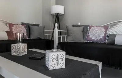 a living room with a couch and a table with pillows at Sophia's Castle View Apartment in Chania Town
