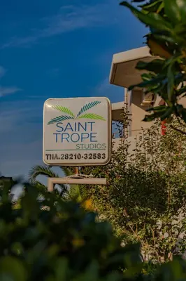a sign for aame tropic studios on the side of a building at Saint Trope Studios in Kalamaki Chanion