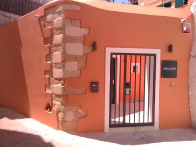 an orange building with a gate in front of it at Antica Canea Luxury Rooms in Chania Town