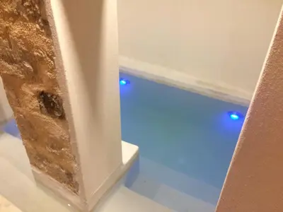 a bath tub with blue lights in a room at Antica Canea Luxury Rooms in Chania Town