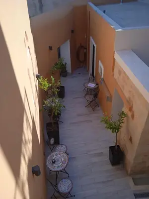 an empty hallway with chairs and tables and potted plants at Antica Canea Luxury Rooms in Chania Town