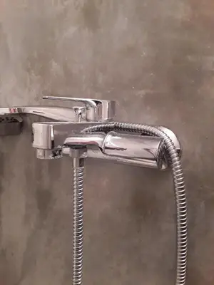 a chrome shower head with a hose at Waves House in Kissamos